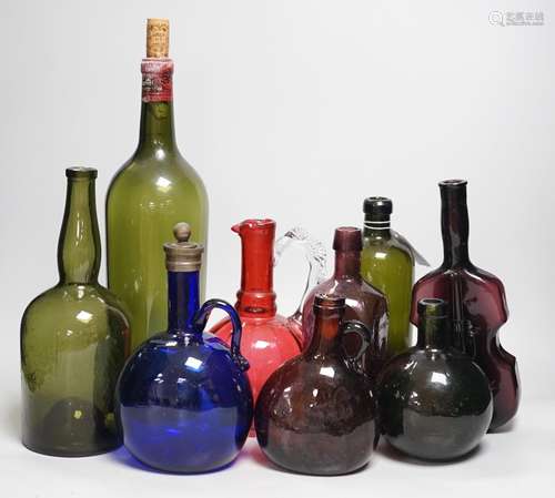 A collection 19th/20th century coloured glass bottles and ju...