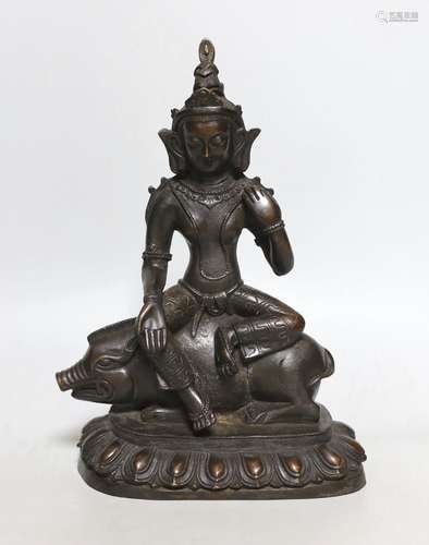 A buddhist bronze figure of Marici seated on a boar, 26cms h...