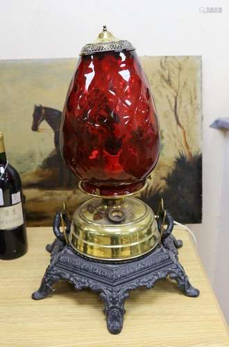 A floor-standing cranberry glass, brass and iron-mounted lam...