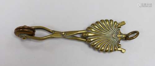 A brass skirt hem lifter. 14cm long