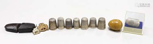 Nine assorted silver thimbles, including one in fitted leath...