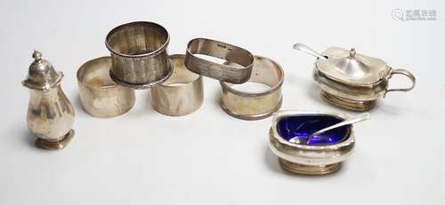 Five assorted silver napkin rings and a George V silver thre...