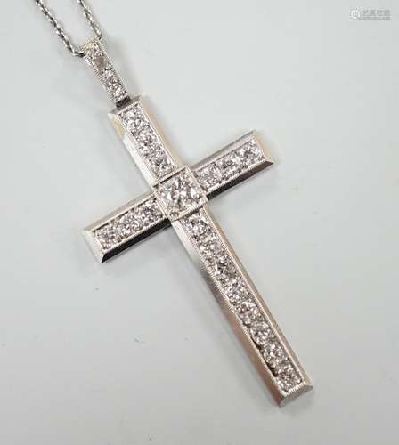 A white metal(stamped platin) and diamond set cross pendant,...