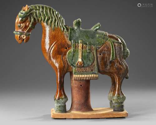 A CHINESE GREEN AND BROWN  GLAZED HORSE, MING DYNASTY (1368-...