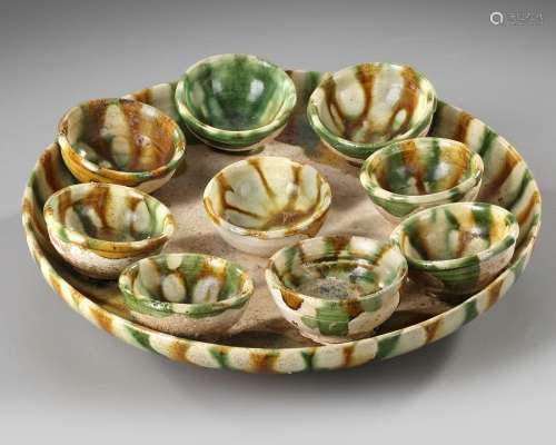A CHINESE SANCAI GLAZED TRAY AND NINE CUPS, TANG DYNASTY (61...