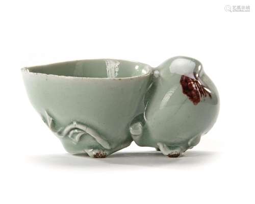 A CHINESE CELADON WATER DROPPER IN THE SHAPE OF A PEACH, KAN...