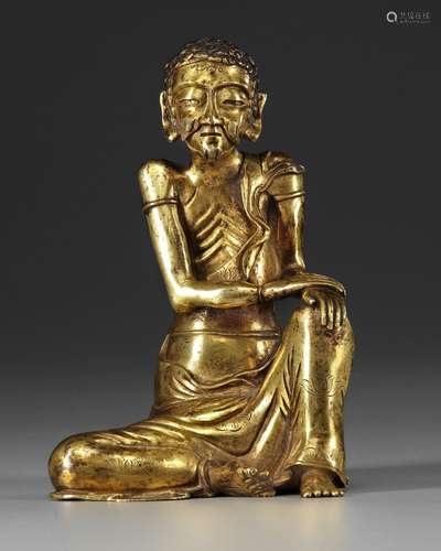 A GILT-BRONZE SEATED FIGURE OF THE ASCETIC SHAKYAMUNI, 17TH ...