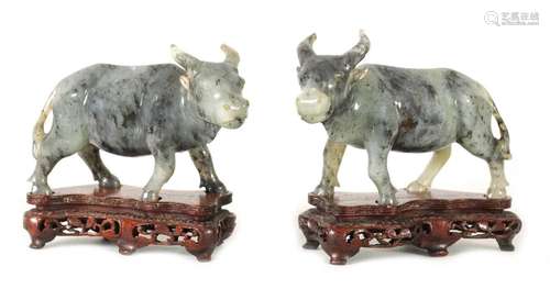 A PAIR OF CHINESE-CARVED GREY JADE MODELS OF WATER BUFFALO