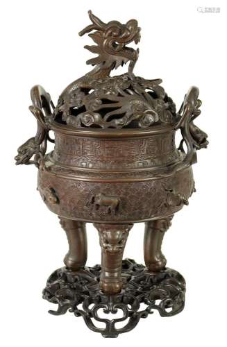 A 19TH CENTURY CHINESE BRONZE CENSER AND LID MOUNTED ON A HA...
