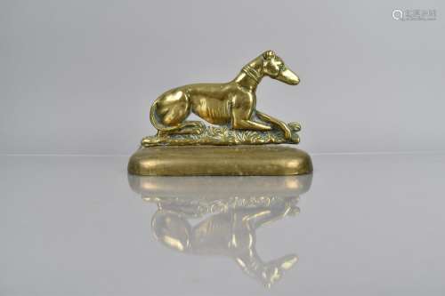 A 19th Century Brass Doorstop in the Form of a Recumbent Gre...