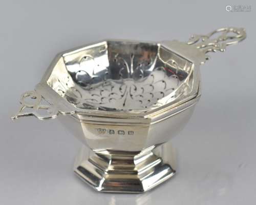A George VI Silver Tea Strainer and Stand by Mappin and Webb...