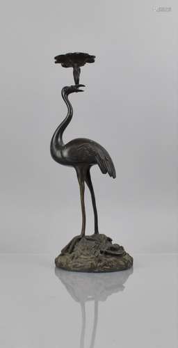 A Japanese Bronze Candlestick in the Form of Crane Holding L...