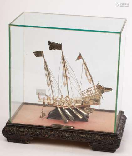 Two Chinese white metal junk boats, 20th Century, in glass c...