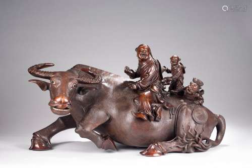 A VERY LARGE ROSEWOOD CARVING OF BUFFALO AND BOYS