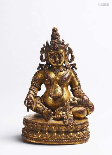 A TIBETAN GILT COPPER FIGURE OF JAMBHALA