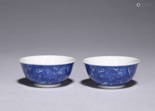 A PAIR OF REVERSE DECORATED BLUE AND WHITE DRAGON CUPS