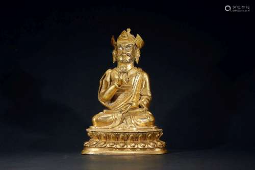 A GILT-BRONZE FIGURE OF GURU