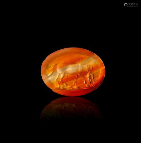 A GREEK CARNELIAN INTAGLIO OF A HORSE EATING HELLENISTIC PER...