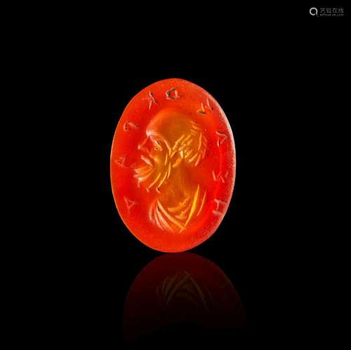 A ROMAN CARNELIAN INTAGLIO DEPICTING AN ELDER MAN WITH INSCR...