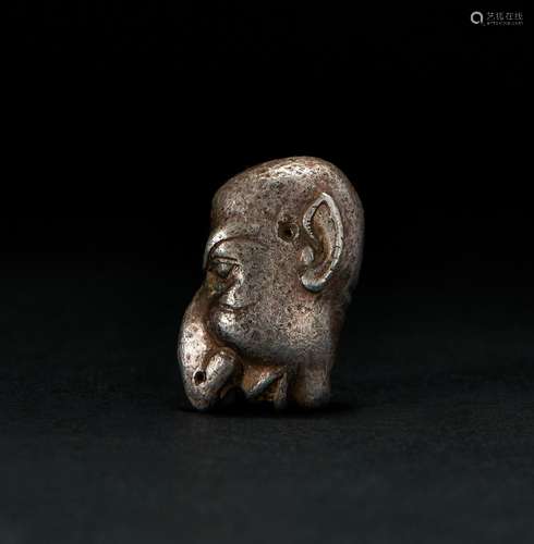 A ROMAN SOLID SILVER AMULET OF A "GROTESK" FACE, C...