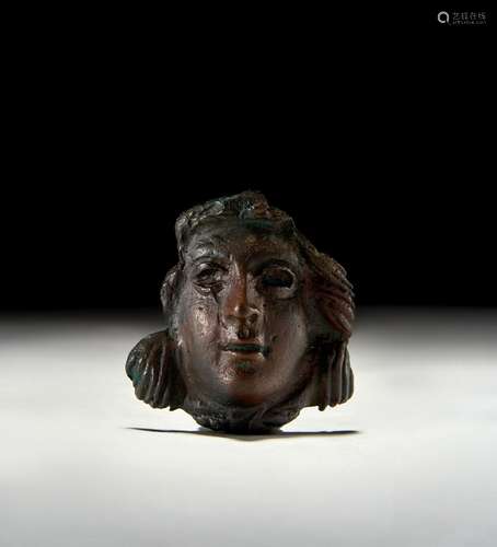 A ROMAN BRONZE FRAGMENTED FACE, 3RD CENTURY A.D. OR LATER