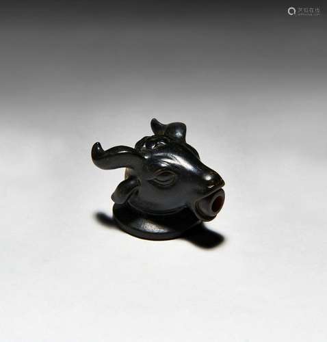 A ROMAN OBSIDIAN PENDANT DEPICTING A HEAD OF A BULL, CIRCA 2...