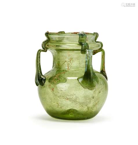 A LATE ROMAN GLASS FOUR-HANDLED JAR CIRCA 4TH-5TH CENTURY A....