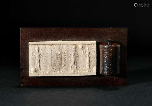 A NEAR EASTERN AGATE CYLINDER SEAL DEPICTING A GODDESS WITH ...