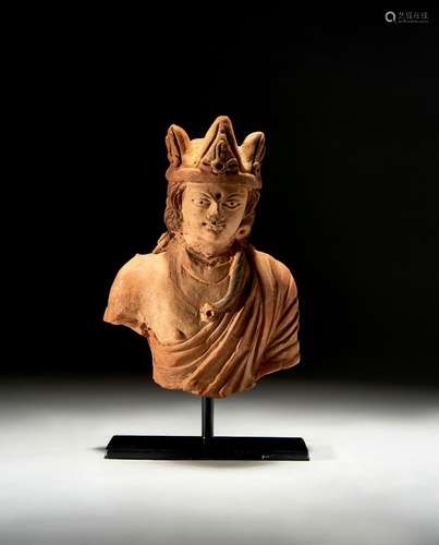 A GANDHARA TERRACOTTA BUST OF A CROWNED KING, CIRCA 5TH CENT...