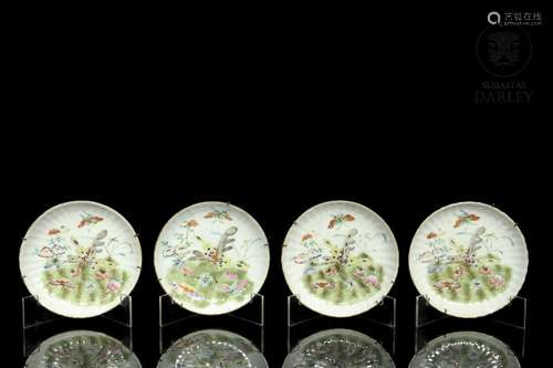 Set of four enamelled plates, 20th century