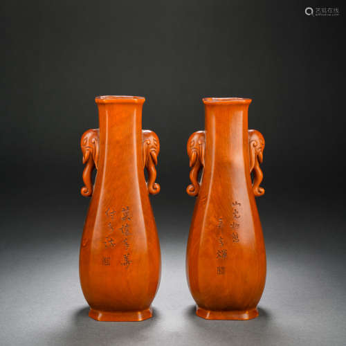 A pair of wood-carved poetry and elephant ear bottles