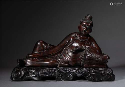 A WOODEN RECLINING BUDDHA STATUE