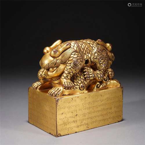 A TIBETAN INSCRIBED BRONZE-GILT BEAST SEAL