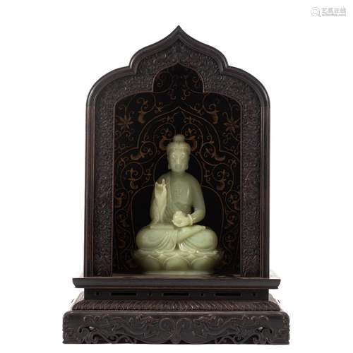 A CHINESE CARVED JADE BUDDHA WITH WOODEN NICHE