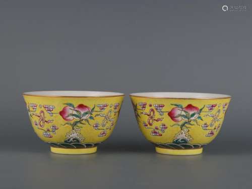 A pair of yellow-ground famille rose bowls with ten thousand...