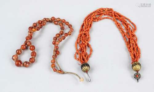 Two necklaces, China or India, 20th c., coral and red transl...
