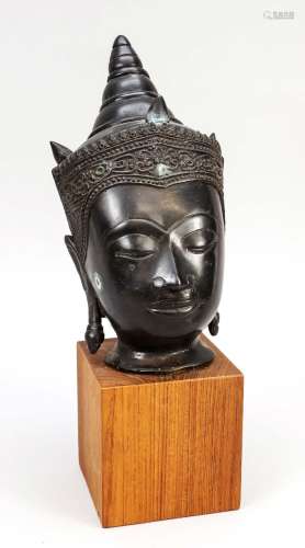 Kinnara head, Thailand, date uncertain, heavy bronze head of...