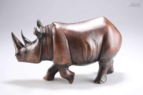 AN EARLY 20TH CENTURY HARDWOOD MODEL OF A RHINOCEROS