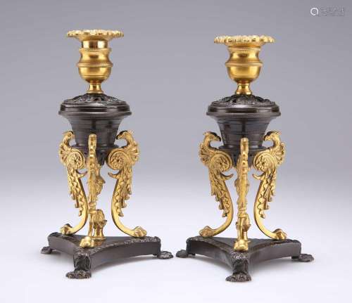 A PAIR OF REGENCY PATINATED AND GILT BRONZE DWARF CANDLESTIC...