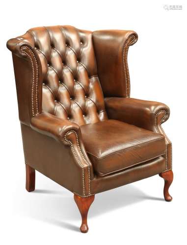 A BROWN LEATHER CHESTERFIELD WING-BACK ARMCHAIR