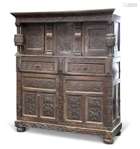 A LARGE CARVED OAK COURT CUPBOARD