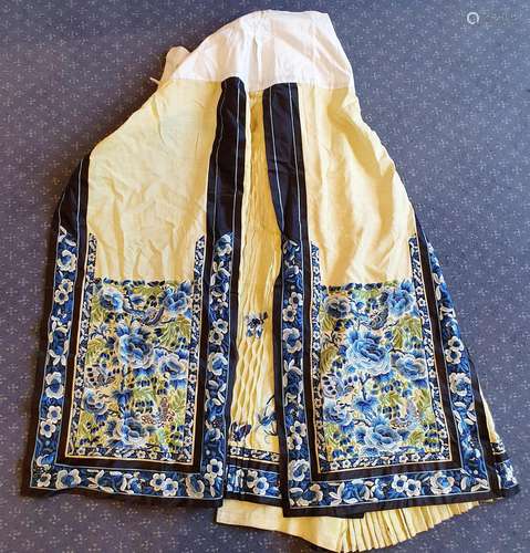 A Chinese silk skirt, embroidered with blue flowers