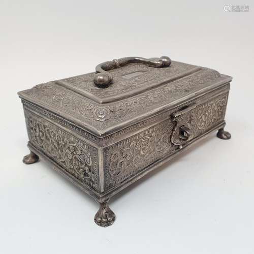 An Eastern silver coloured metal casket, with a ring handle,...