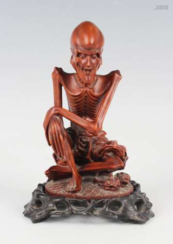 A Chinese carved boxwood figure of a seated arhat