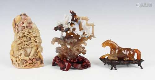 A Chinese carved and pierced agate figure group of two drago...