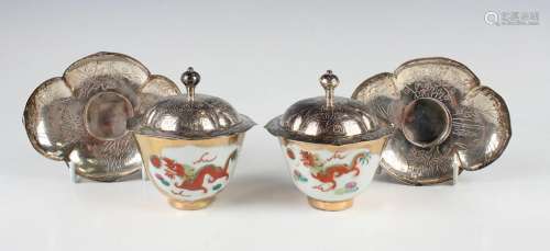 A pair of Chinese porcelain teabowls with silver covers and ...