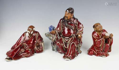 A Chinese Shiwan pottery sang-de-boeuf glazed figure of Guan...