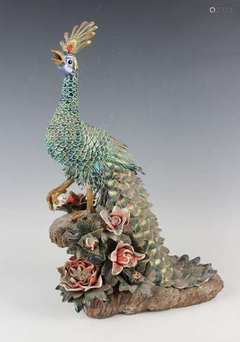 A Chinese pottery model of a peacock