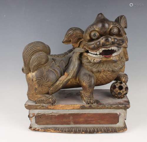 A Chinese carved giltwood figure of a Buddhistic lion