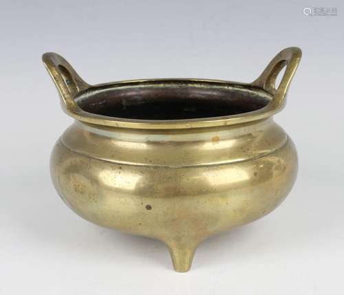 A Chinese polished bronze tripod censer